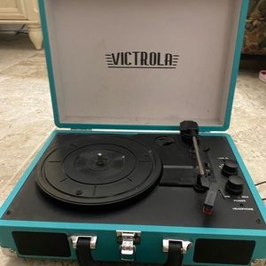 Victrola suitcase record player in teal blue.